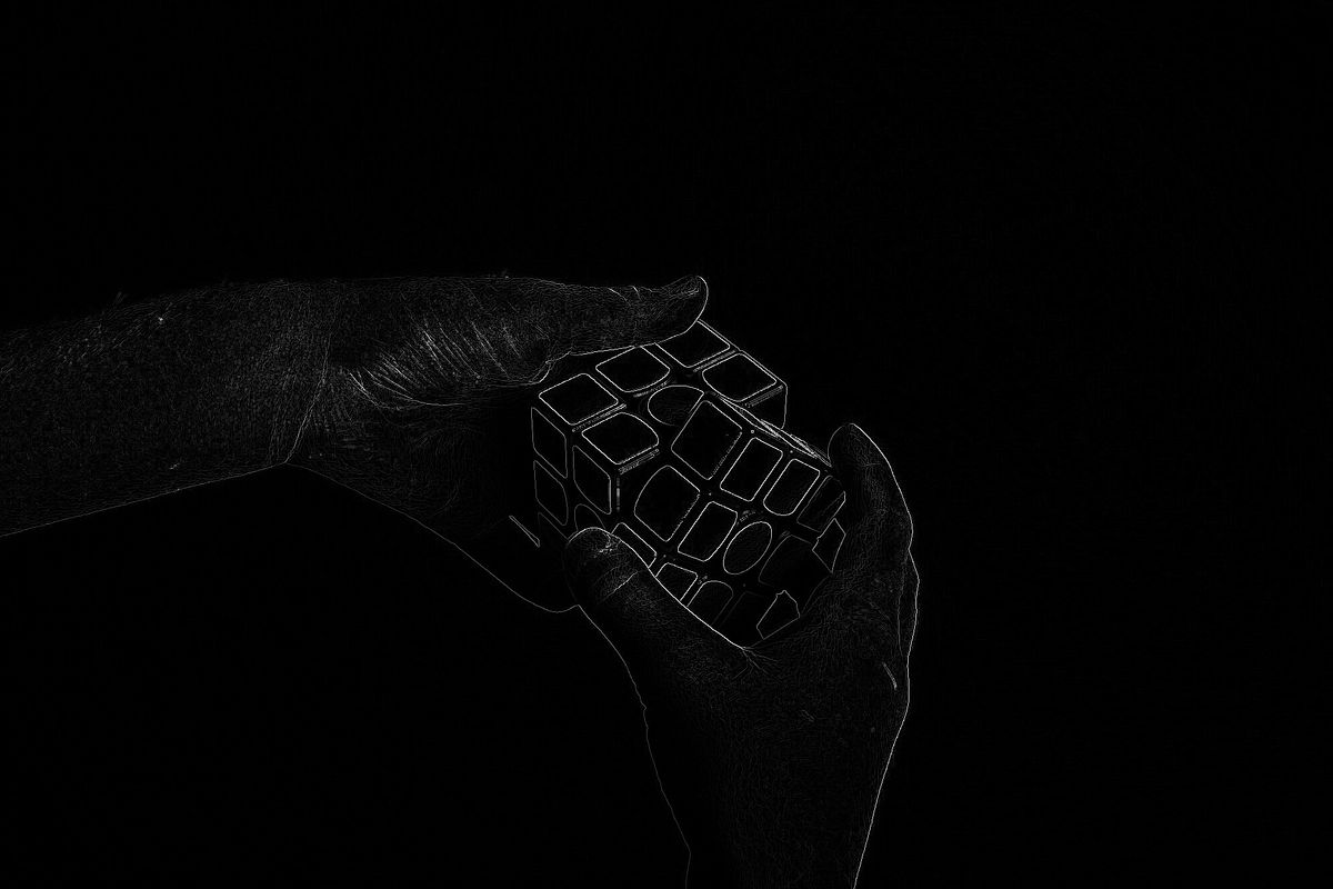 Two hands rotating a Rubiks Cube